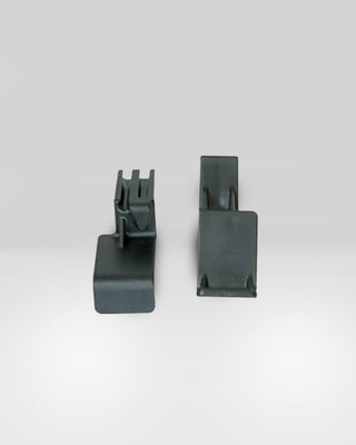 Close-up view of two components from Click's Easy Squeeze kit, highlighting their design for easier kennel door handling.