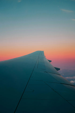 Wing of airplane at sunset