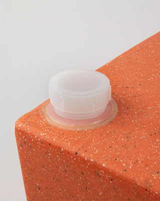 WaterHole™ replacement cap installed on orange WaterHole™, close up.