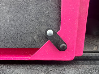Close-up view of CackleBox™ latch installed on a hot pink CackleBox™, right side, latched shut.
