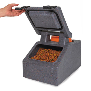 Close-up of a hand opening the Chow Box™, revealing dry dog food inside, emphasizing convenience for pet owners.