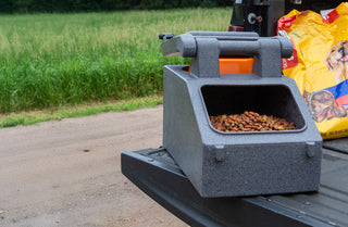 Pet food dispenser on a truck bed with a field in the background