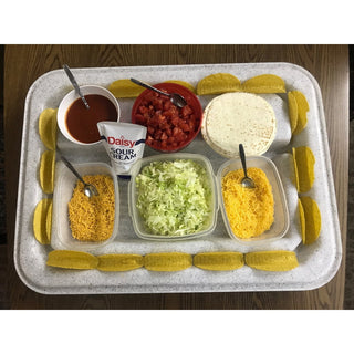 A colorful taco spread arranged on a Clean Cut® station, featuring bowls of toppings and taco shells.