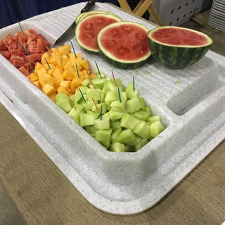 An assortment of diced fruits including watermelon, cantaloupe, and honeydew displayed on a Clean Cut® station.