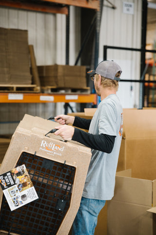 Employee lifting RuffLand Performance Kennel