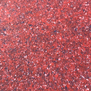 Close-up of a textured red surface, illustrating vibrant color suitable for pet products or play areas.