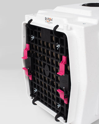 White pet carrier with a black grid door featuring pink easy squeeze latches on a white background